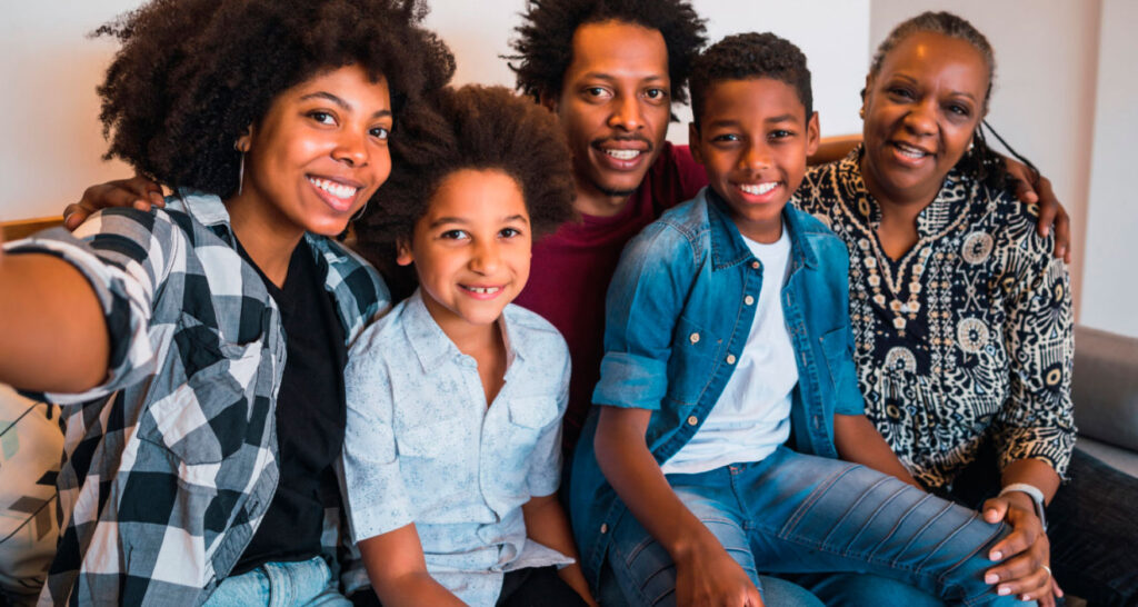 family of 5 smiling on sofa